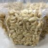 Premium W180 cashew kernels vacuum-sealed in transparent food-grade bags to preserve freshness and crunch.