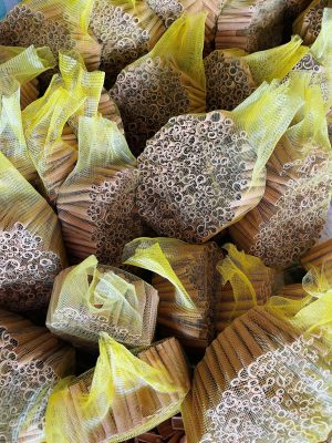 High-quality Premium Tube Cassia Vietnam featuring a bright golden-brown color, neatly packed in yellow export mesh bags.