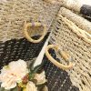 Detailed view of the woven handles on both sides of the seagrass basket, securely reinforced for carrying heavy loads, demonstrating sophistication in both design and function.