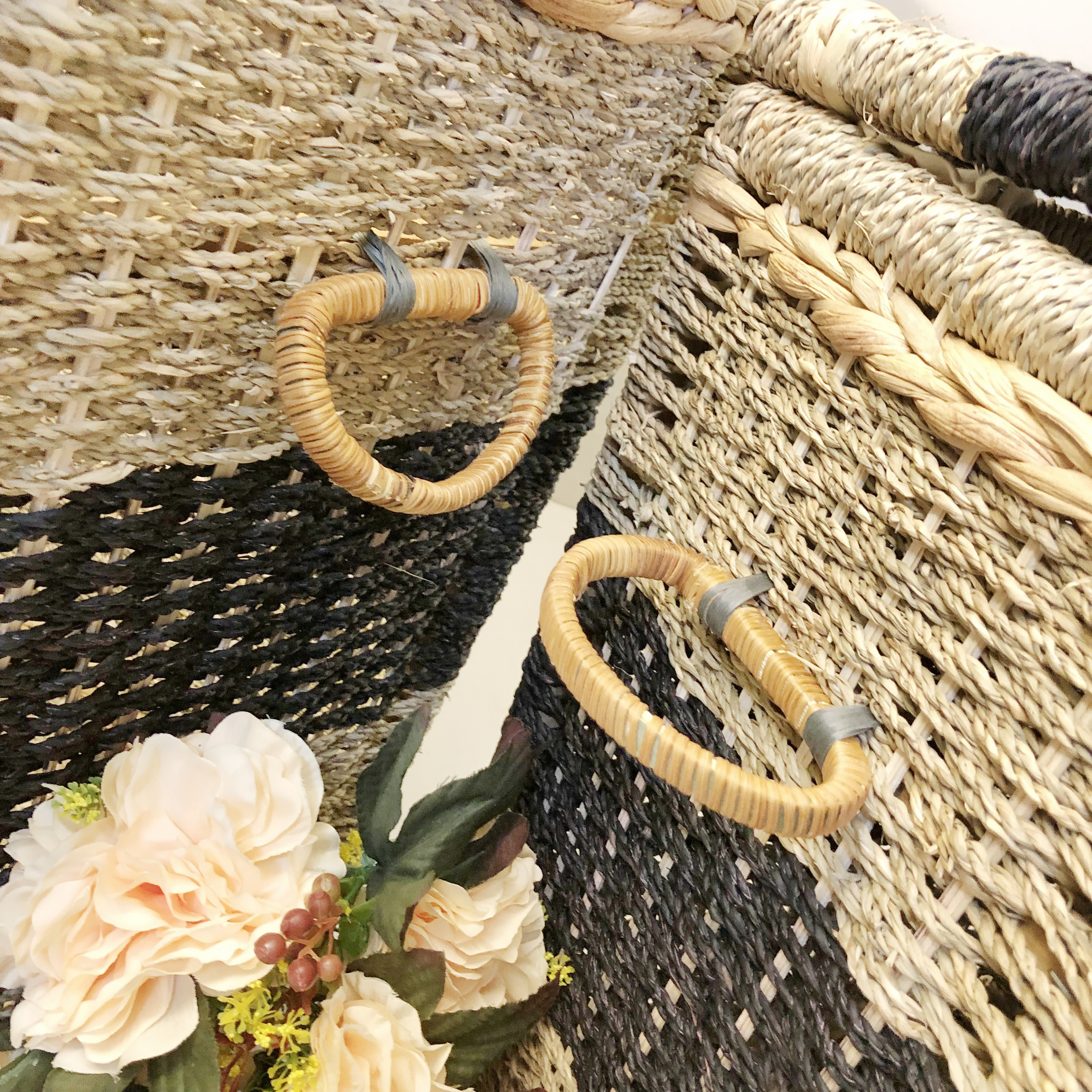 Detailed view of the woven handles on both sides of the seagrass basket, securely reinforced for carrying heavy loads, demonstrating sophistication in both design and function.