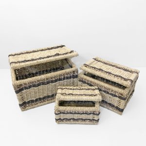 Set of three natural seagrass storage baskets with modern black stripes.