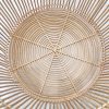 Reinforced woven bottom of natural rattan storage basket.