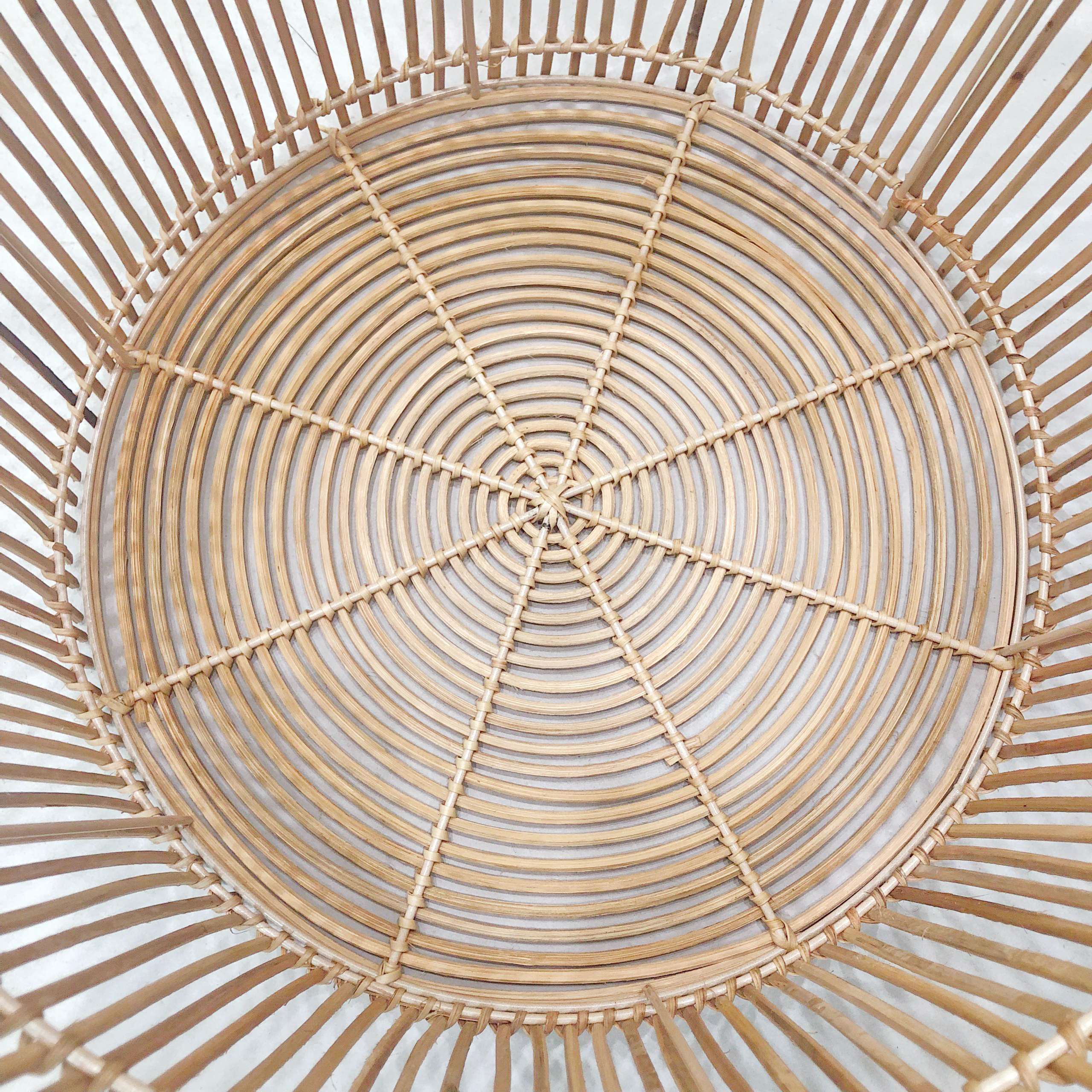 Macro detail of concentric circular weave on rattan basket lid.