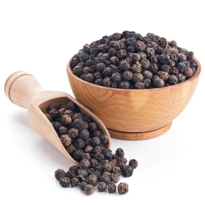 Organic Black Peppercorns overflowing from a wooden bowl and scoop.