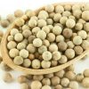 Close-up of whole white peppercorns filling a wooden spoon.